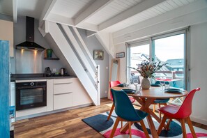 Enjoy meals in the kitchen with an oven and range hood, then dine at the adjacent round table with four chairs.