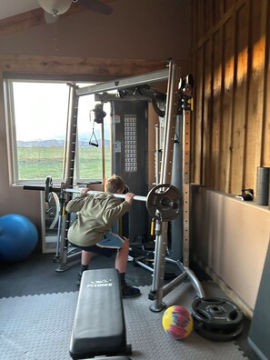 Work out in style with a variety of exercise equipment and a serene view of the surrounding landscape.