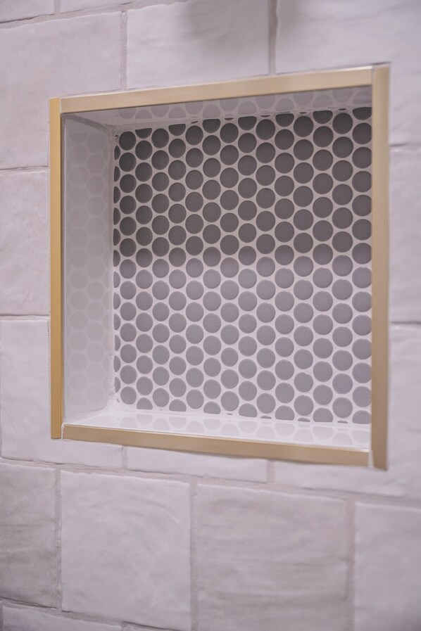 A wall with a square window featuring a honeycomb pattern.