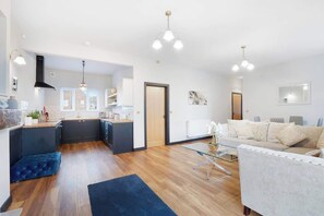 A modern living space with a kitchen, dining area, and a sofa. - Modern 2 Bedroom Home With TV, WiFi, Parking (Hetton-le-Hole)