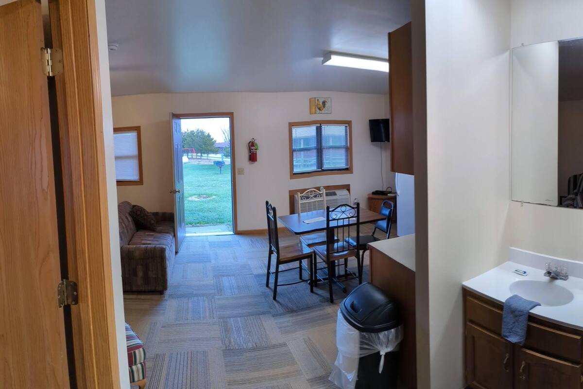 A bathroom with a shower, a sink, and a mirror.