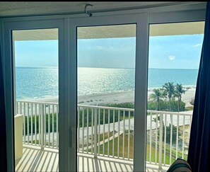 A balcony with a view of a beach and ocean. - Sunset & Ocean Front Views-FM-Beach(Pool is Open) (Fort Myers Beach)