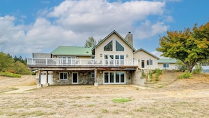 A two-story house with a stone foundation, a green roof, and a balcony. - Vineyard Farmhouse in Oakland w/ Hot Tub! (Oakland)
