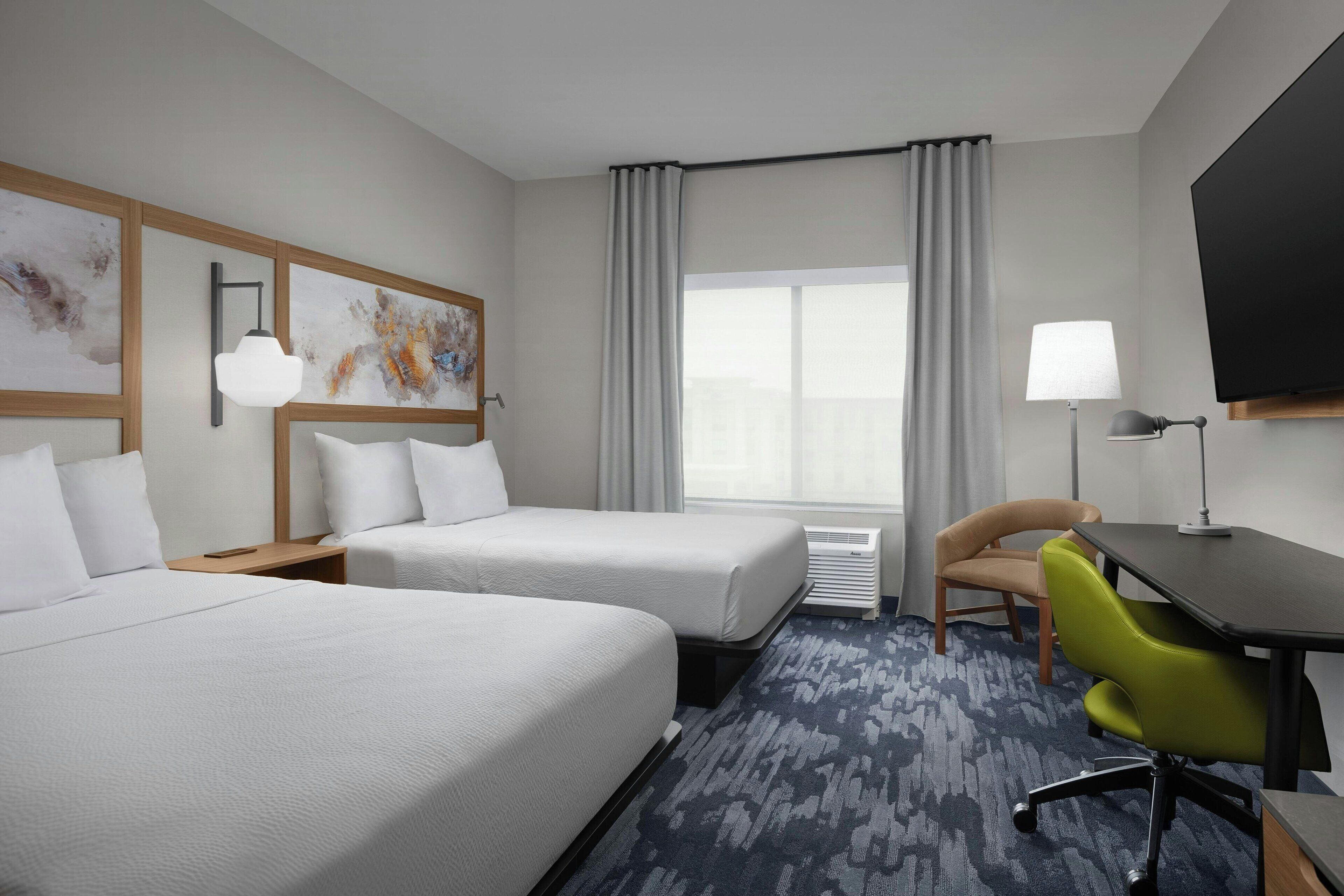 Hypo-allergenic bedding, desk, laptop workspace, blackout drapes