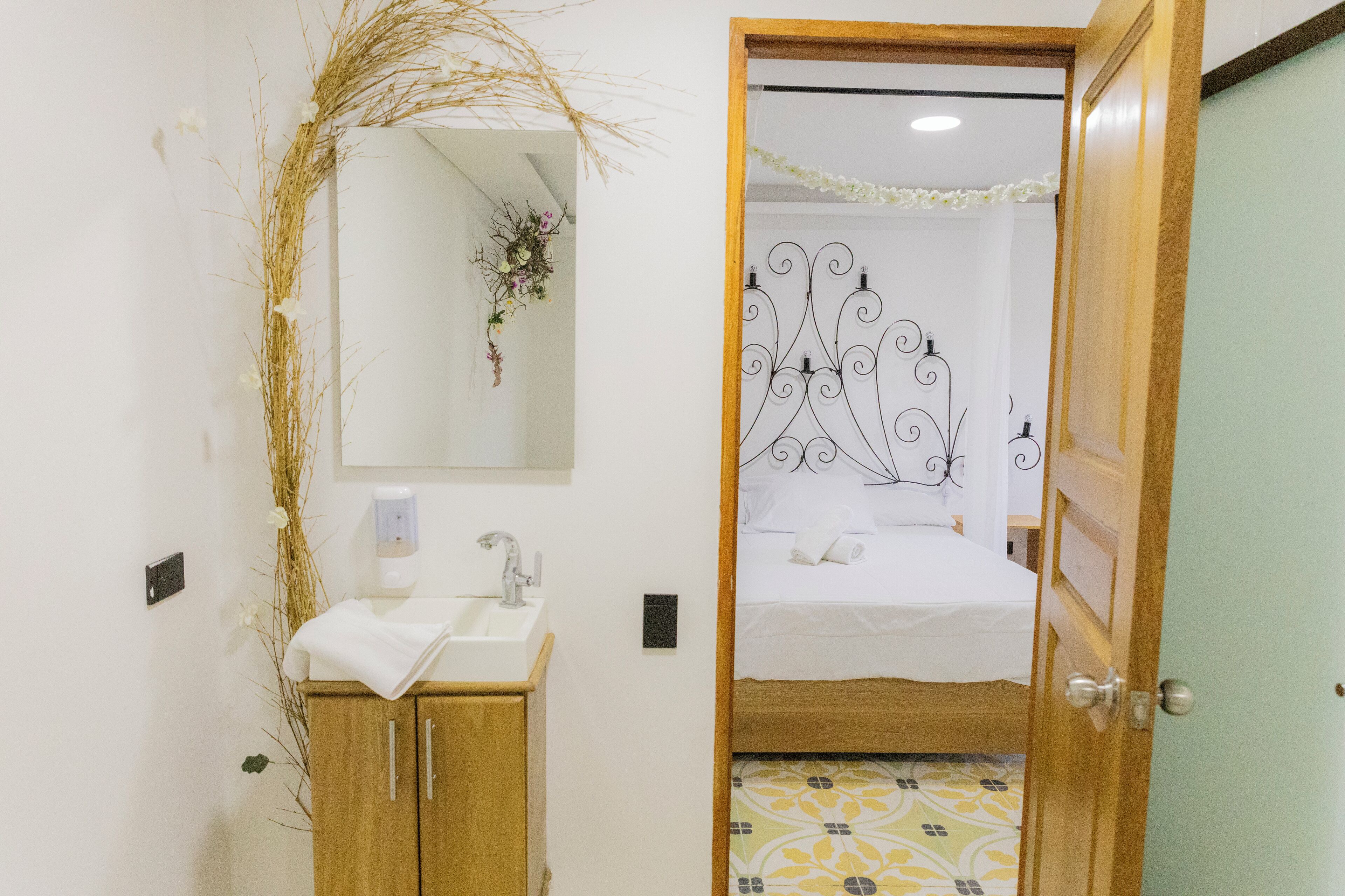 A bathroom with a wooden cabinet, a sink, and a mirror.