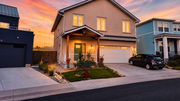 A two-story house with a garage, a driveway, and a well-maintained front yard with plants. - 2BR Apt + Sauna in Earth House, Minutes to Boulder (Superior)