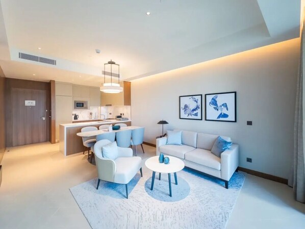 Relax in a cozy living space with a central seating area, dining nook, and kitchenette.