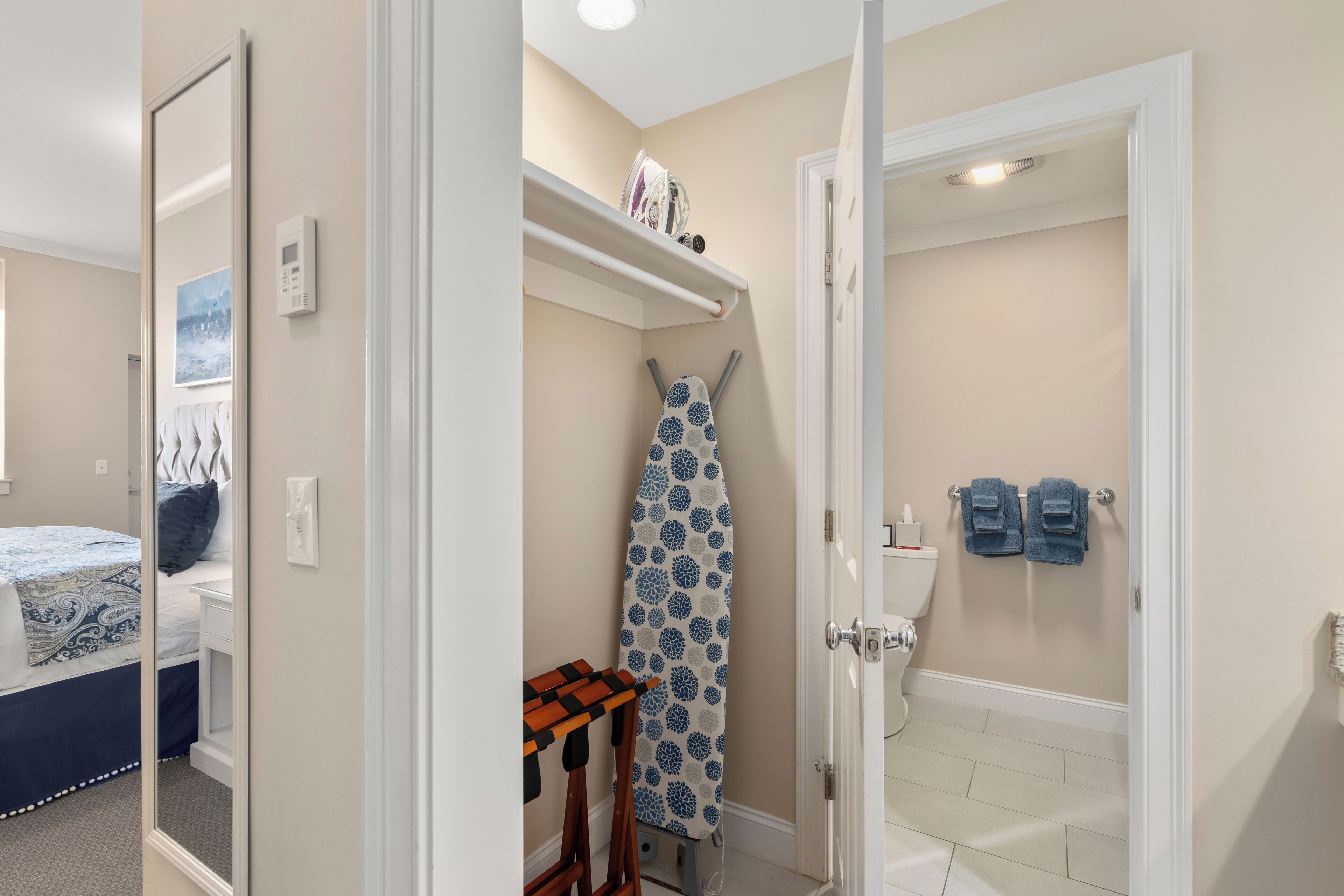 A bathroom with a toilet, a shower, and a towel rack.