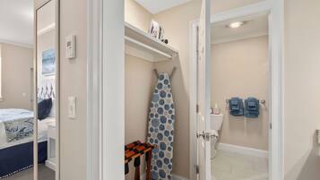 A bathroom with a toilet, a shower, and a towel rack.