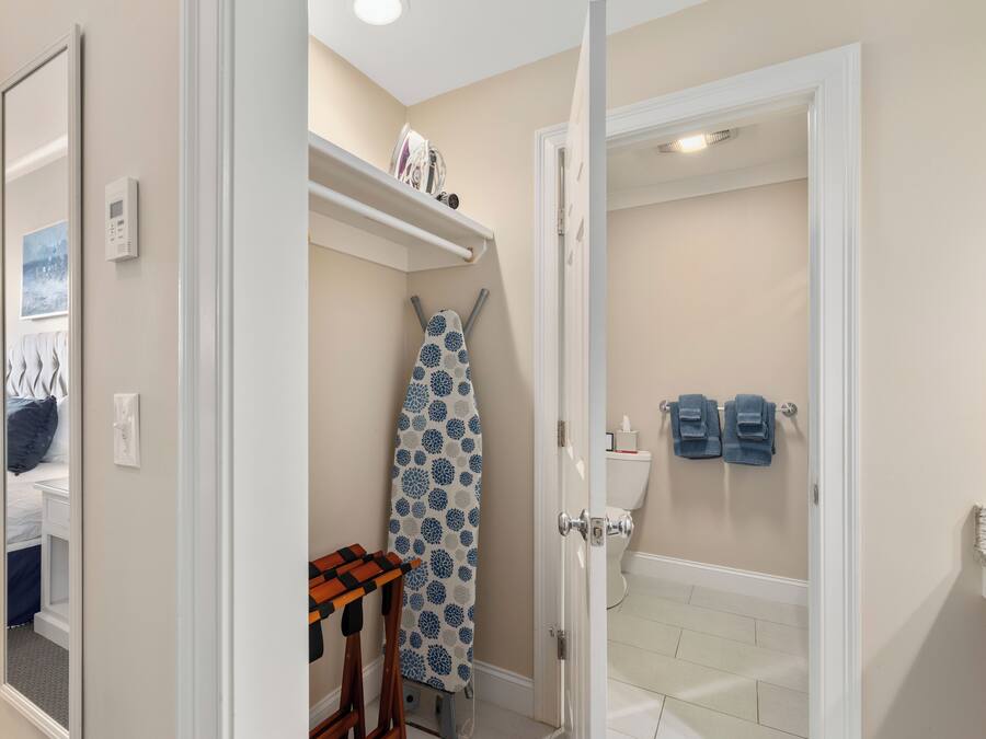 A bathroom with a toilet, a shower, and a towel rack.