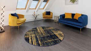 A modern living room with a blue sofa, yellow armchairs, and a round rug. There are skylights and a painting on the wall. - 3 bedroom accommodation in South Boisdale (South Boisdale)