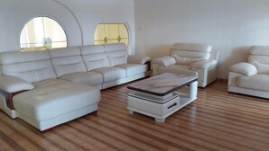 A spacious living room with a sectional sofa, a chaise lounge, and a coffee table.