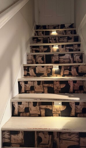 A staircase with wooden steps and a white door at the top.