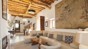 A spacious living room with a wooden ceiling, a large painting, and a cozy sofa set. - Awesome home in Sant Antoni de Portman (Sant Antoni de Portman)
