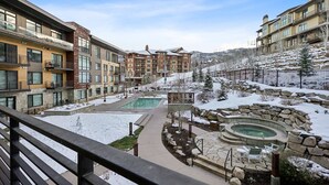 A resort with a pool, hot tub, and snow-covered landscape. - Ski-In/Ski-Out Residence In The Heart Of Canyons Village (Park City)