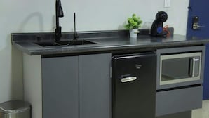 A kitchen with a built-in dishwasher, a microwave, and a sink.