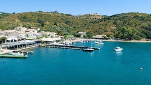 A coastal marina with boats docked, surrounded by residential buildings and hills in the background. - Villa Anastasia: Amazing views of Kerasia, private pool, WiFi, A/C (Sinies)