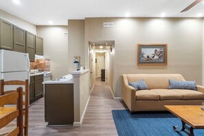 A compact living space with a kitchenette, a sofa, and a dining area.