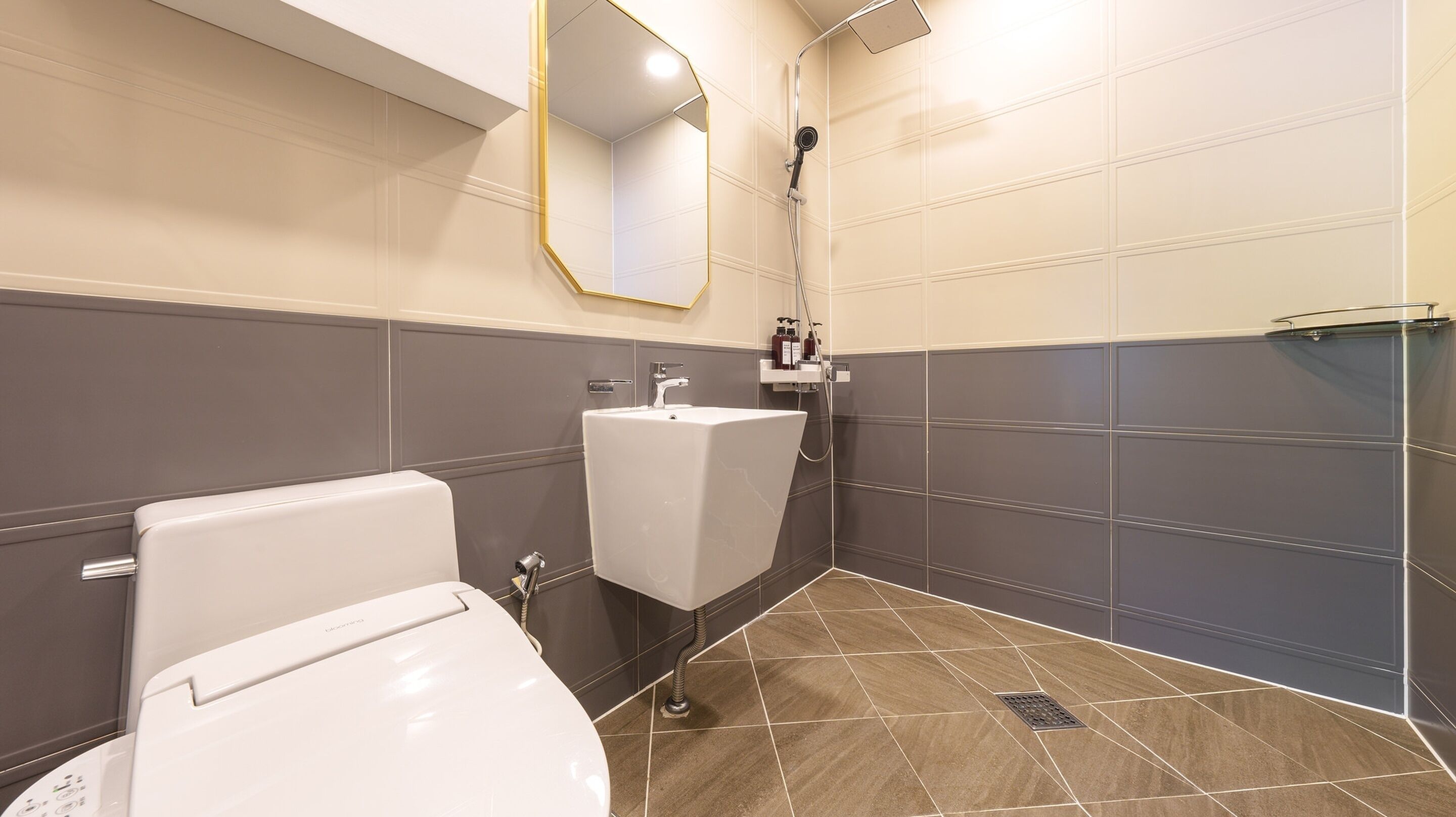 A modern bathroom with a toilet, sink, and shower.