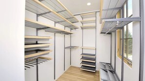 A narrow, modern hallway with built-in shelving units and a wooden floor. - Lovely Home on Museum Hill-walk to Plaza/Canyon Rd (Santa Fe)