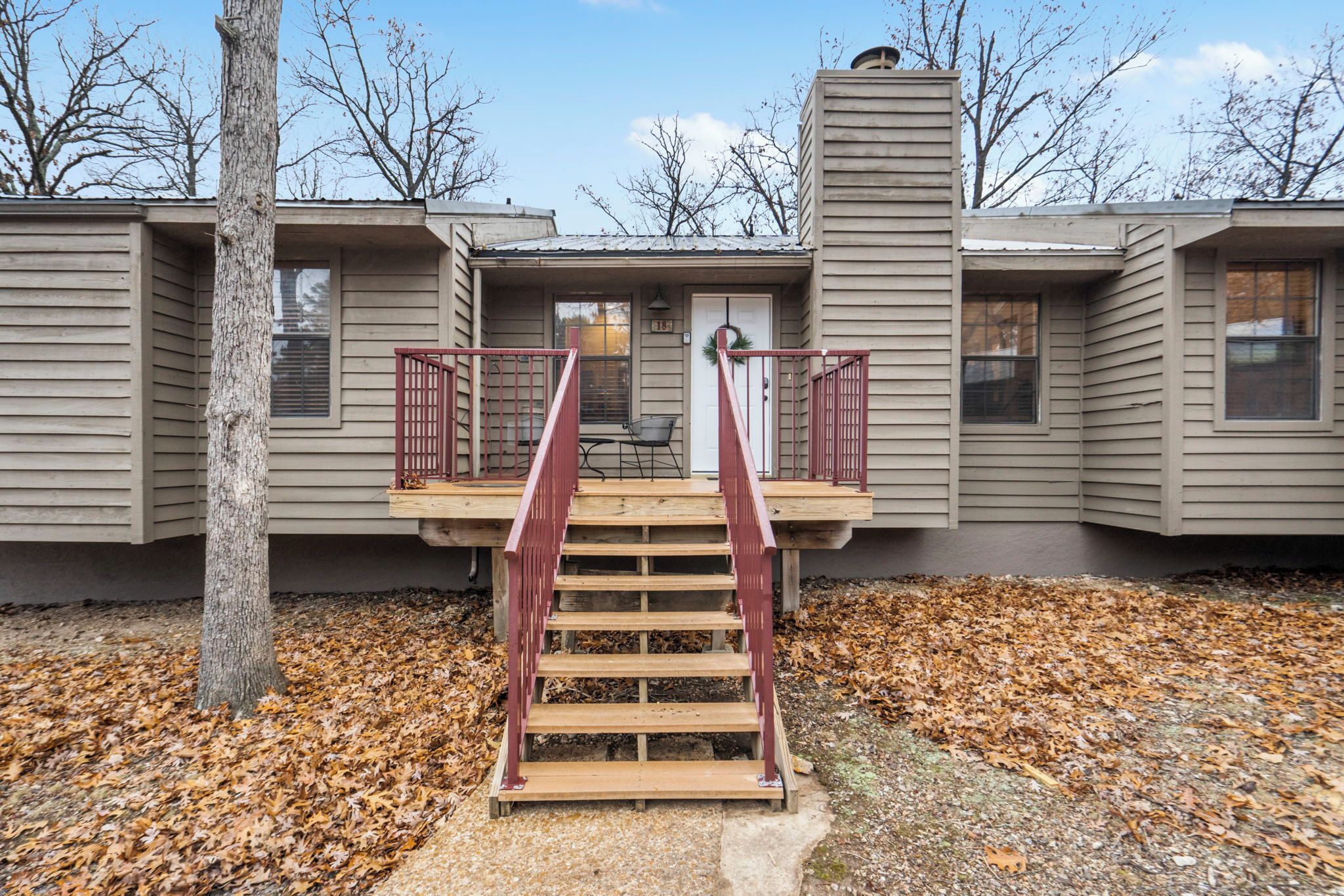 A two-story building with a wooden staircase leading to a front door.