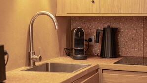 A modern kitchen with wooden cabinets, a stainless steel sink, a kettle, and a coffee maker. - Charming Studio With A/C - 2P - Center St Tropez (Saint-Tropez)
