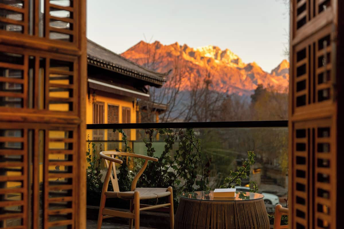 A traditional wooden room with a view of mountains.