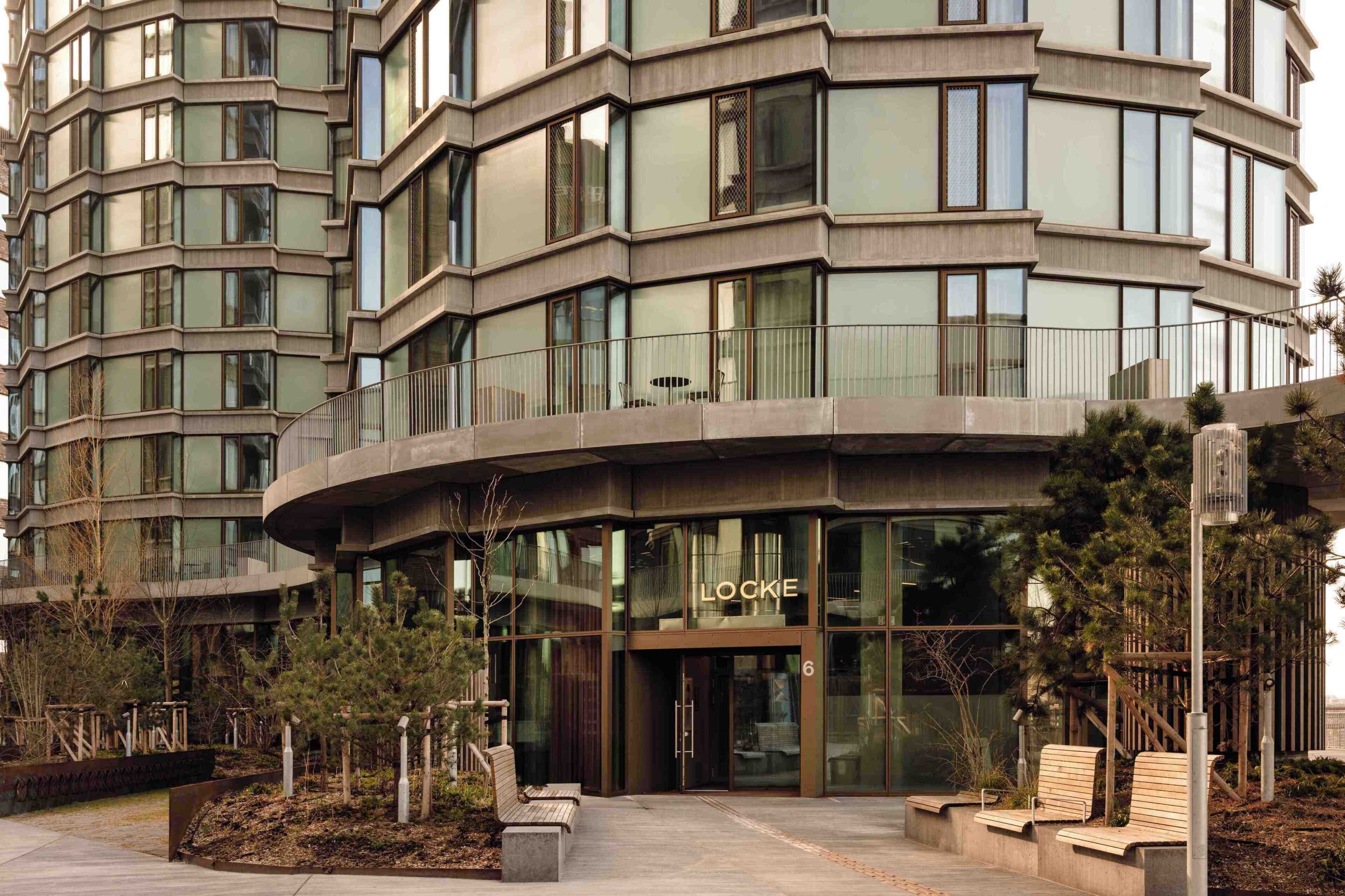 A modern building with a curved facade, large windows, and a visible entrance labeled 'LOOKE'.