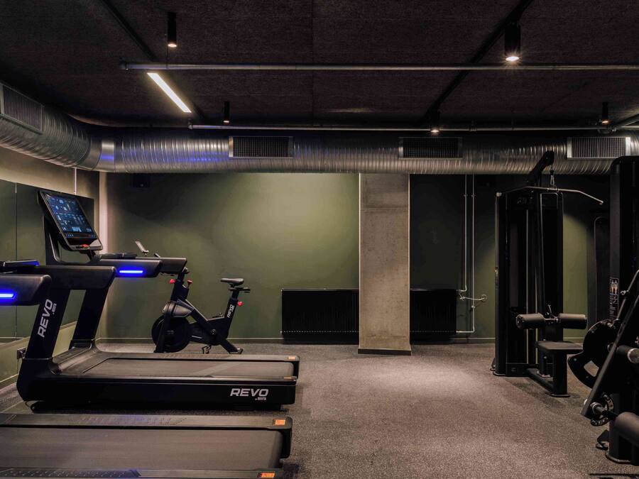 A gym with treadmills, an exercise bike, and weight machines.