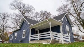 A two-story house with a porch, a chimney, and a number '401' on the side. - Hamilton Hideaway  (Fortville)