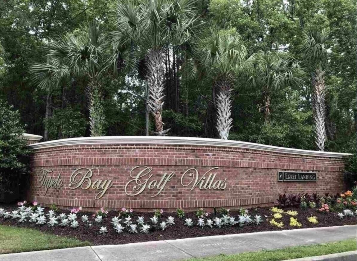 A brick wall with the text "Tipelo Bay Golf Villas" and "Egrett Landing" indicating a golf resort location.