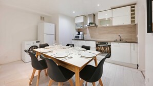 A modern kitchen with white cabinets, a built-in microwave, and a dishwasher.