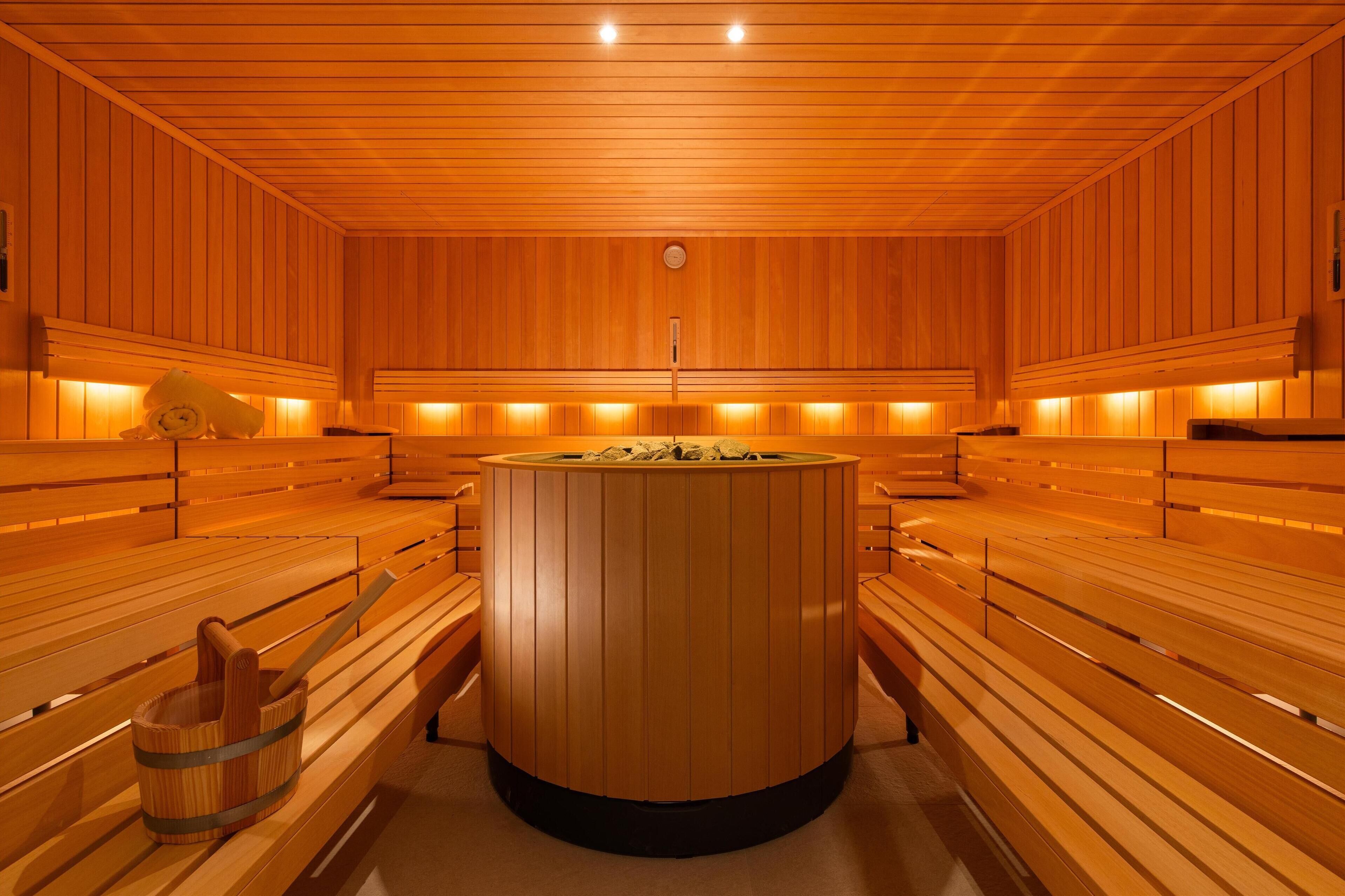 A sauna with wooden benches and a central steam room.