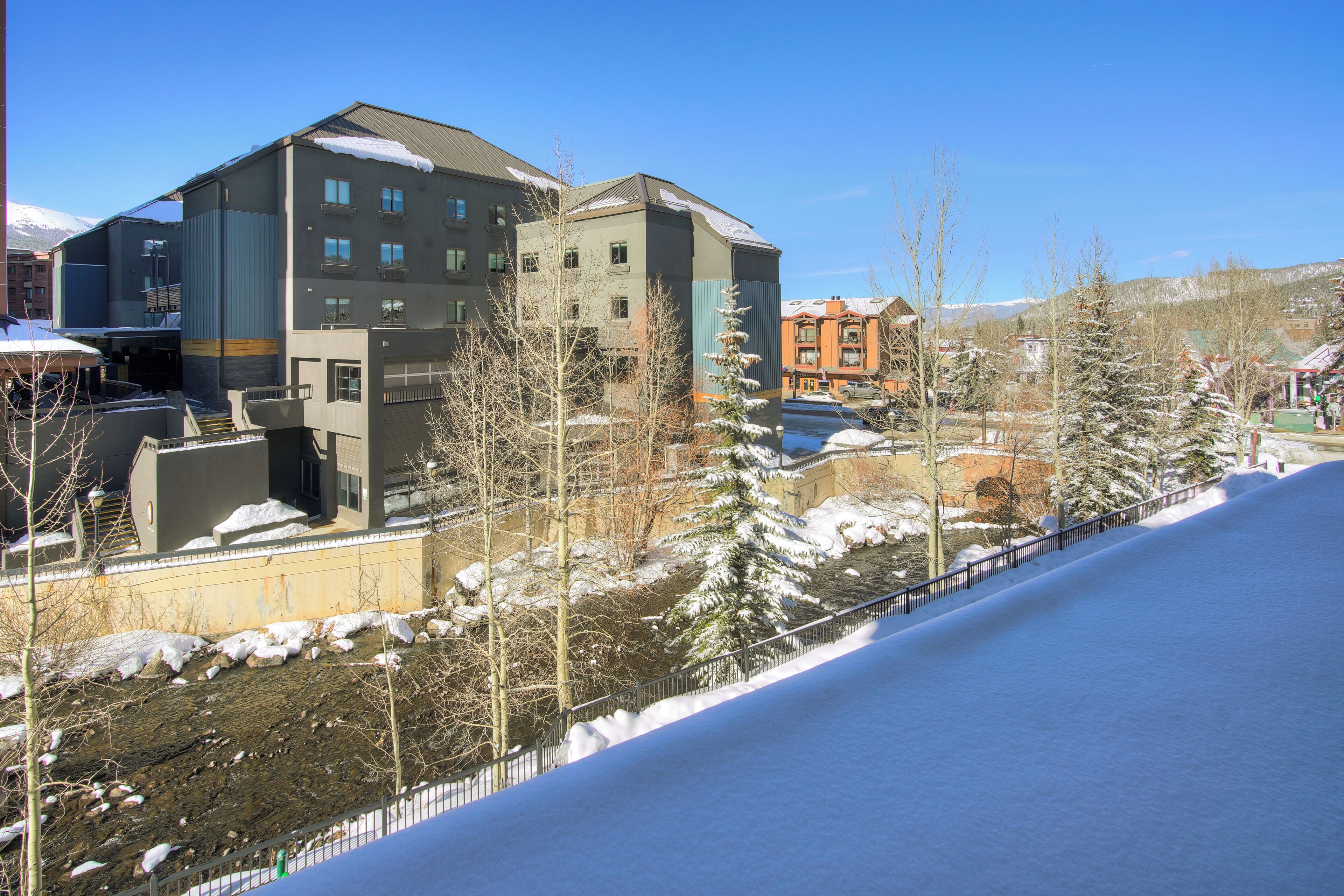 A multi-story building with a modern architectural design, featuring a mix of balconies and large windows.