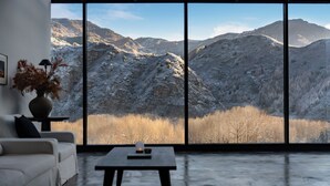 A modern interior with a large window offering a view of snow-covered mountains. - Thanks Hotel (Xinzhou)