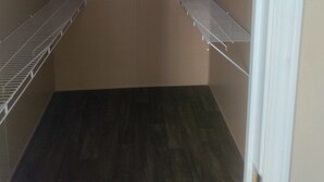 A walk-in closet with metal shelving units and a ceiling light fixture. - Reserve your very clean,quiet 3/2 mobile home in West San Antonio w/AC, WiFi (San Antonio)