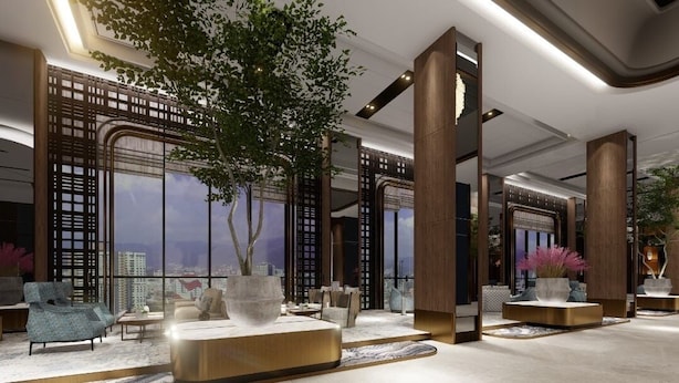 A modern lobby with high ceilings, large windows, and a central tree. - Fifth Avenue Hotel (George Town)