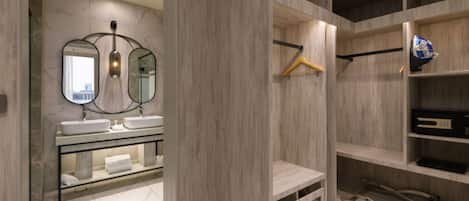 A modern bathroom with dual sinks, a mirror, and built-in shelving.
