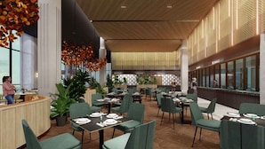 A modern restaurant with green upholstered chairs, wooden tables, and a checkered wall pattern. - Fifth Avenue Hotel (George Town)
