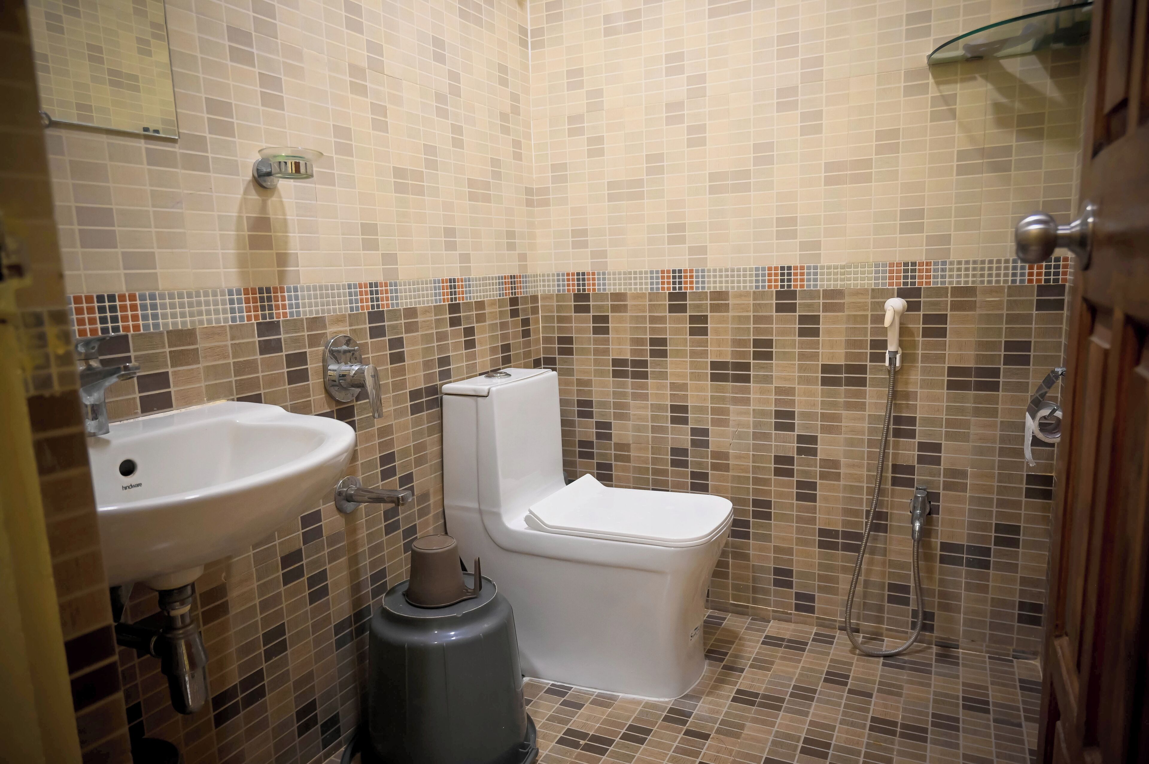 A bathroom with a sink, toilet, and shower.