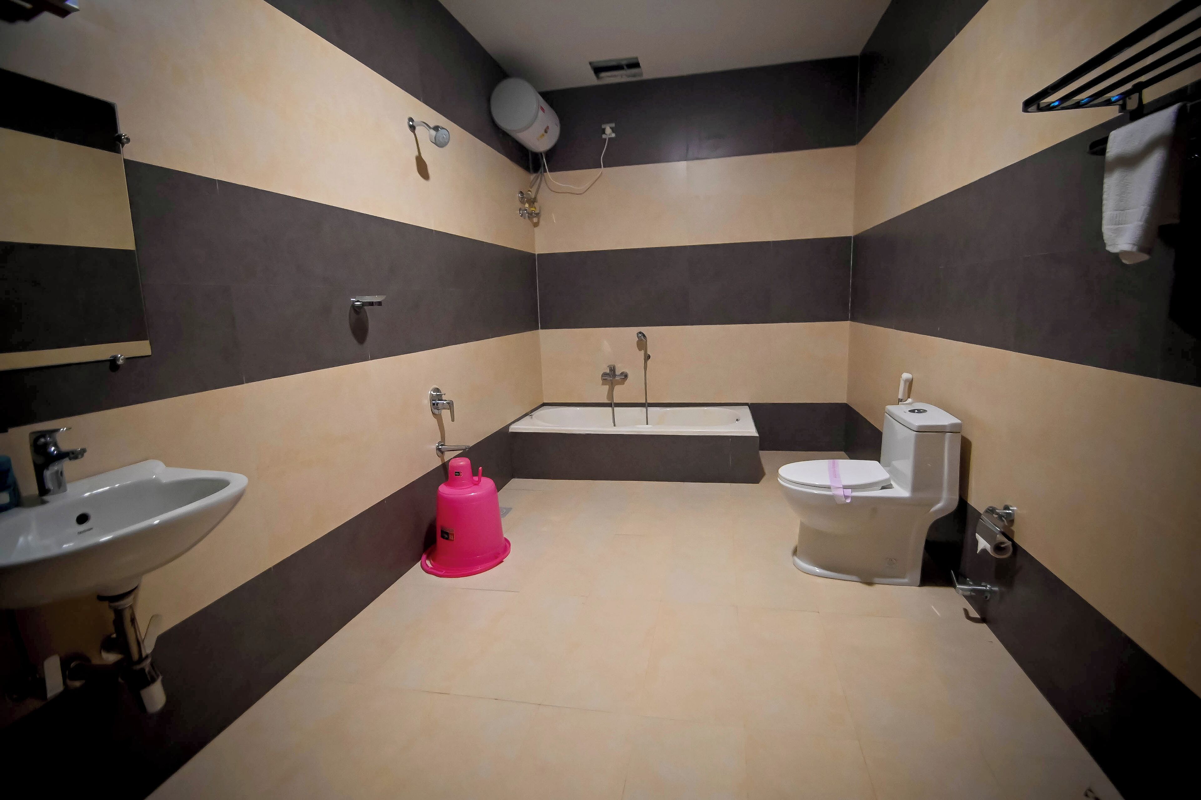 A bathroom with a sink, toilet, and bathtub.