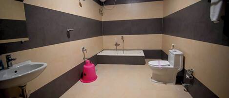 A bathroom with a sink, toilet, and bathtub.