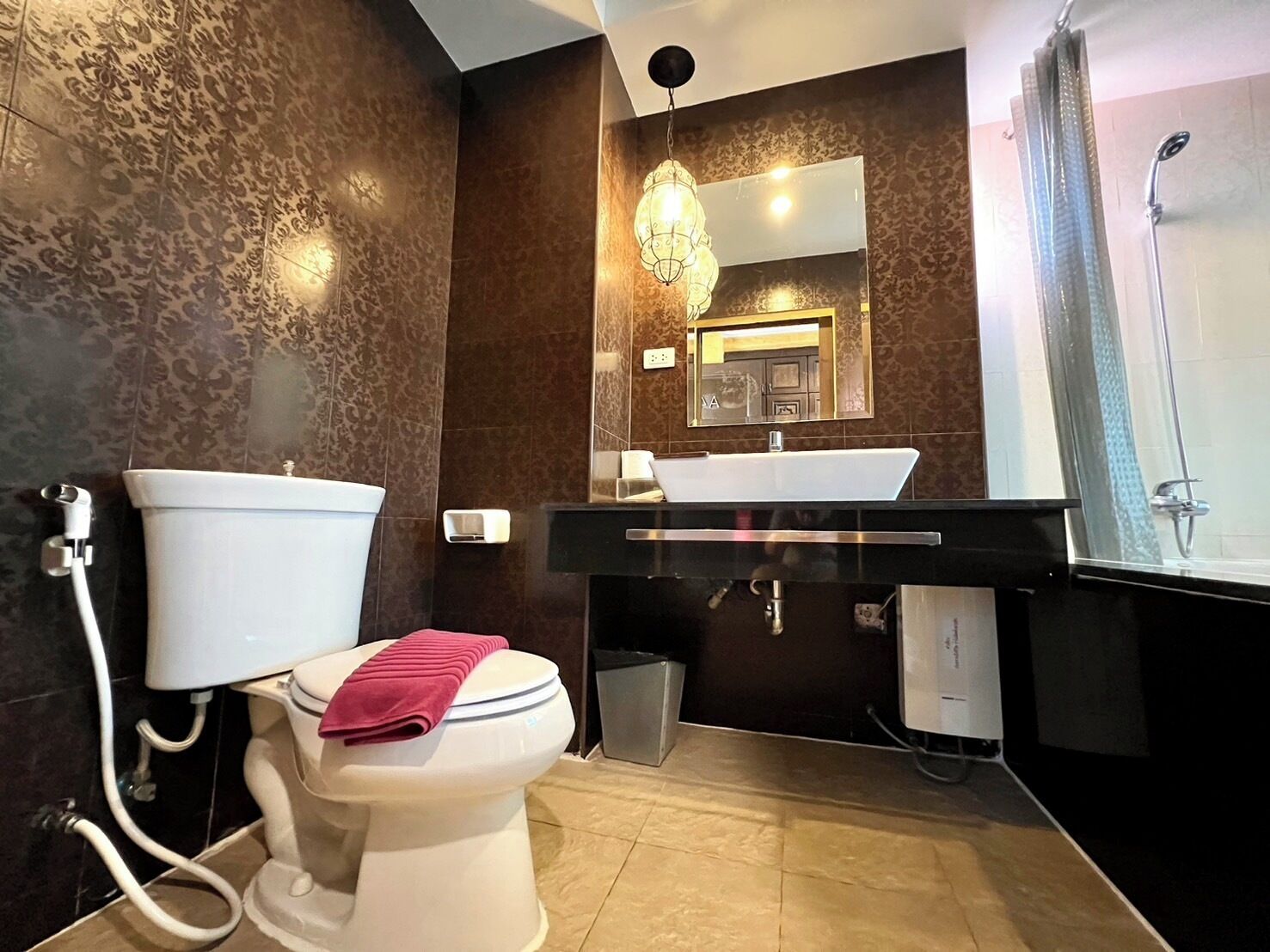 A modern bathroom with a toilet, sink, and shower.