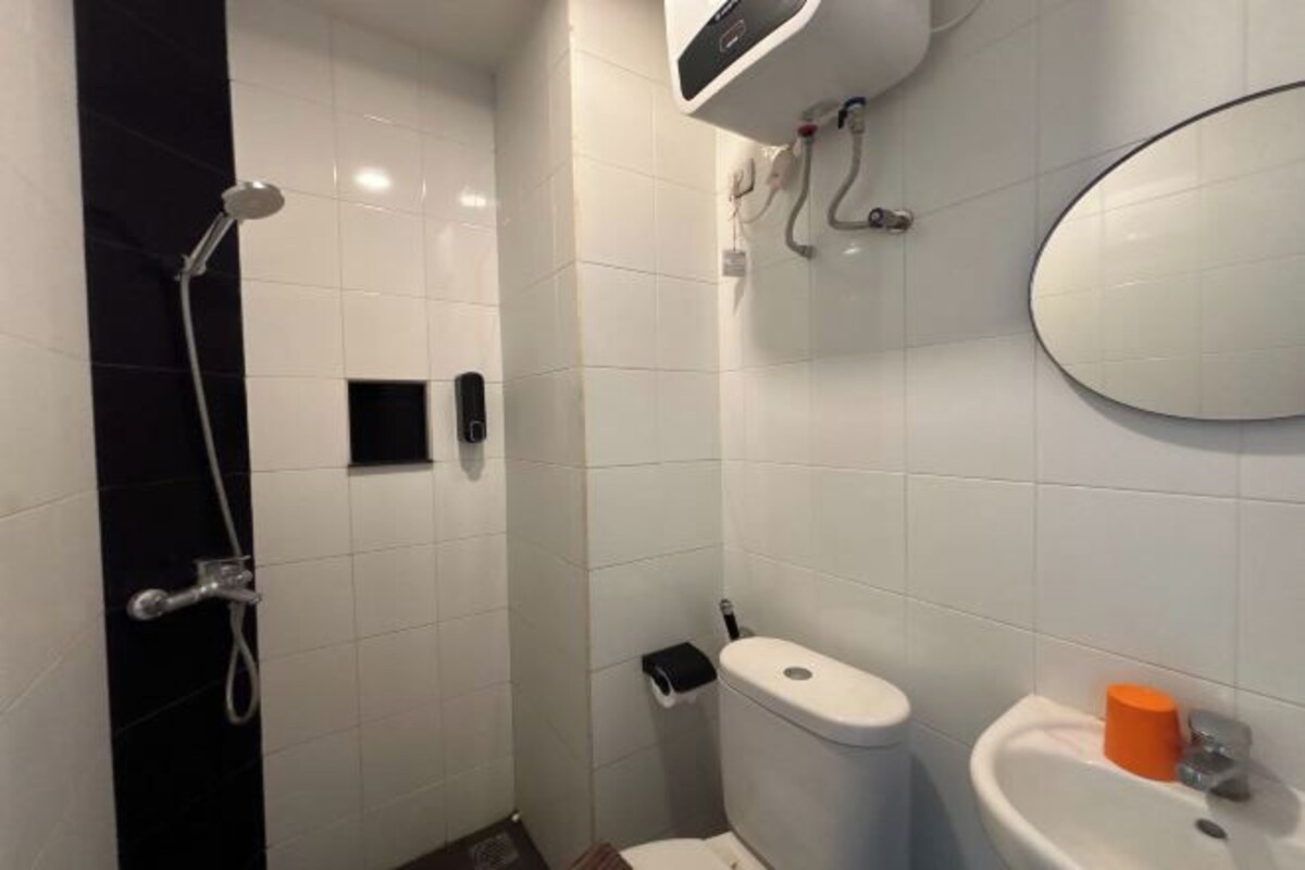 A bathroom with a toilet, sink, and shower.