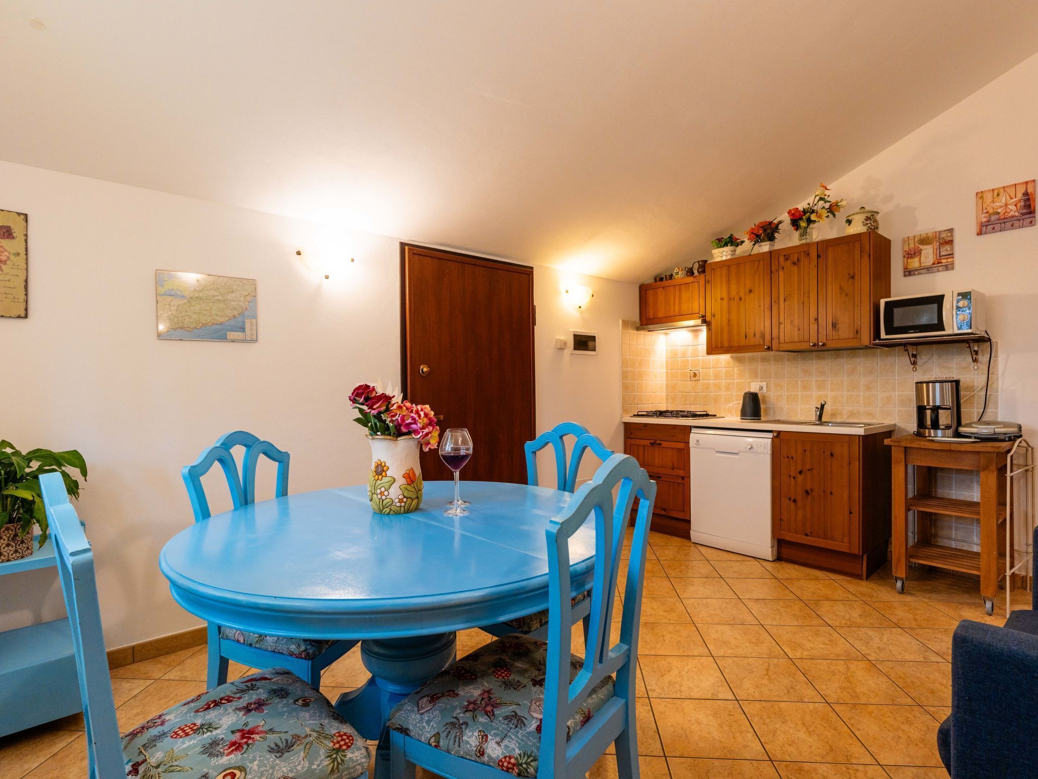 A compact kitchen with wooden cabinets, a microwave, and a sink.