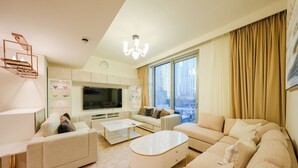 Deluxe Apartment, 2 Bedrooms, City View | Living area | Flat-screen TV