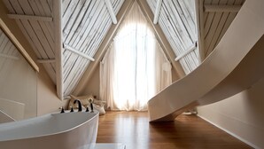 A modern bathroom with a freestanding bathtub, wooden flooring, and a large window with curtains. - Mila Qi Ting Li Guest House Shanghai (Shanghai)