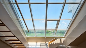 A skylight with a view of a green landscape. - Mila Qi Ting Li Guest House Shanghai (Shanghai)