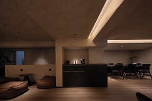 A modern interior with a central island, seating area, and a dining space. - See you soon at Ritz Rose Summer Hotel (Sanya)