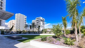A modern urban plaza with a central garden, surrounded by high-rise buildings. - CostaBlancaDreams - Silver Tower 2A in Calpe (Calpe / Calp)